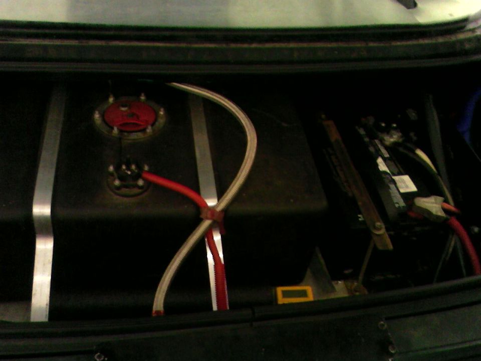 Trunk-mounted fuel cell with braided fuel lines and relocated battery in a race car