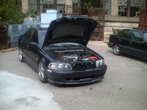 2006 Volkswagen GTI - Two sedans parked outdoors, one with its hood open revealing the engine compartment.