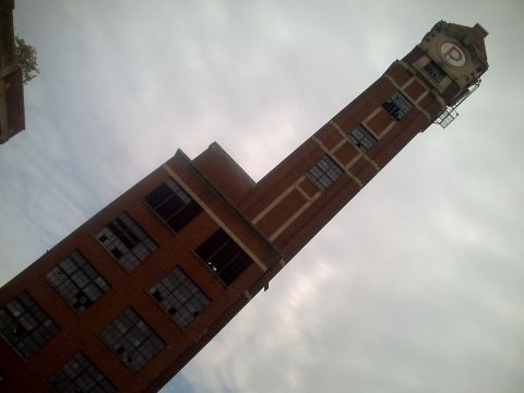 2006 Volkswagen GTI - A brick clock tower with a prominent 'P' logo stands tall against an overcast sky.