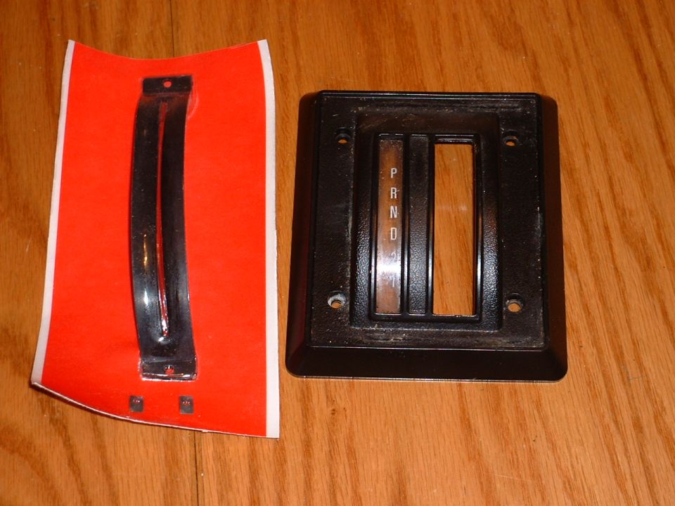 Automatic transmission shifter bezel with P R N D indicator and a separate trim piece on red backing