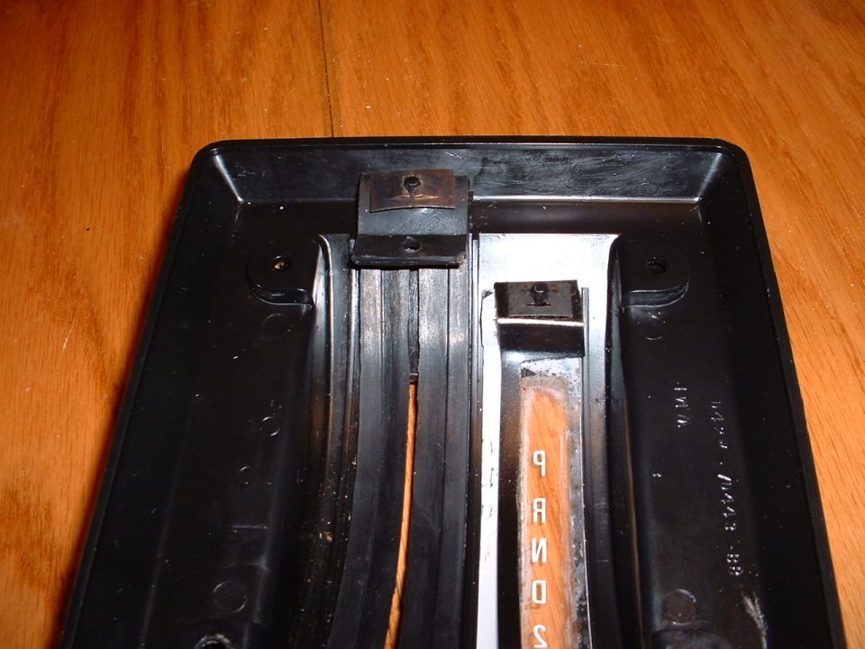 Automatic transmission shifter plate with P R N D S markings. Part number visible on the right