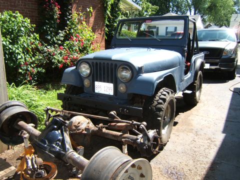 1980 Jeep CJ5 - 1980 Jeep CJ5 in front yard with front axle disassembled and placed in front of the vehicle.