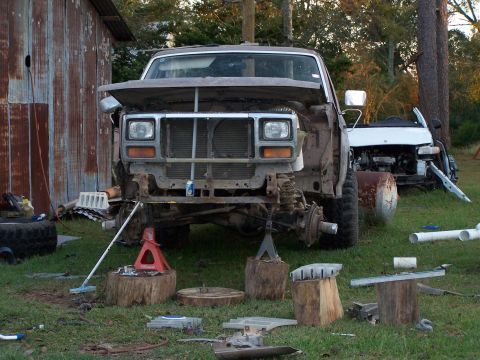 1981 Ford Bronco - This vehicle is missing its front fenders and hood, and is supported by jack stands and wooden blocks.