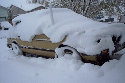 1972 Ford Ranchero - A 1972 Ford Ranchero is partially buried in snow, with another vehicle visible in the background.