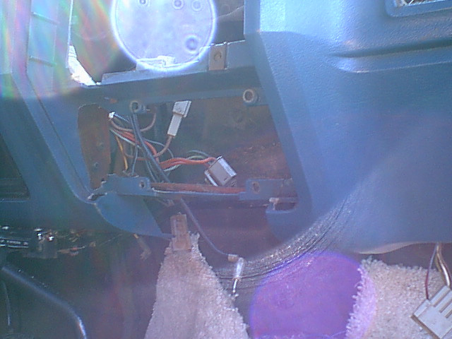 well i had to open the dash up some more to make a good clean fit. You can see the wiring mess behind the dash.