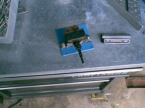 Ok- now to address the tailgate window motor switch issue. i looked thru alot of cars and truck in the junk yard and i came up with this stock switch remounted to a new mount under a Buick station wagon tailgate switch panel. not too bad. The mount is just some scrap i had here in the shop.