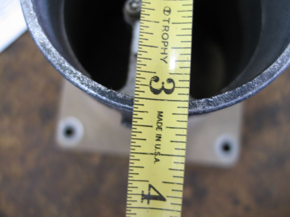 Close-up of a metal MAF sensor with a yellow measuring tape showing inches from 3 to 4