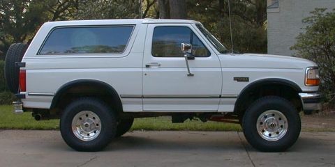 1992 Ford Bronco - This white 1992 Ford Bronco SUV is shown from the side, parked outdoors.