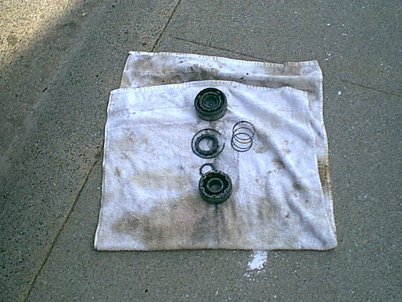 This is the stock hub. from the top down the top is the dial portion of the hub (where you select "Lock" or "Free") the large C in the middle left is the snap ring that holds the inner workings in the hub (after the cover is off this must come out for the hub assembly to come out)the star and spiing in the middle go inside the bottom lockout yhis is what connects the axle to the hub. right above the bottom lockout is the axle C- clip this holds the axle in the lockout.