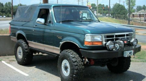 1996 Ford Bronco - This lifted 1996 Ford Bronco features a soft top and aftermarket front bumper with a winch and auxiliary lights.