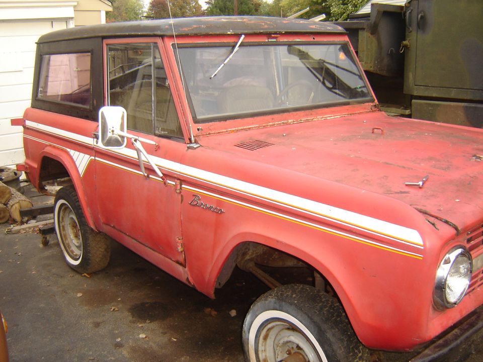 Red vintage SUV with white stripe detail and black top