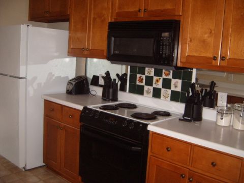 1988 Ford Bronco - Interior view of a kitchen showing appliances, cabinets, and countertop space.