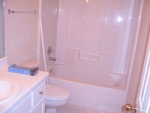 1988 Ford Bronco - A bathroom scene includes a toilet, sink, and bathtub with shower fixtures.