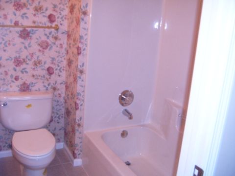 1988 Ford Bronco - Bathroom scene a toilet and bathtub with floral wallpaper.