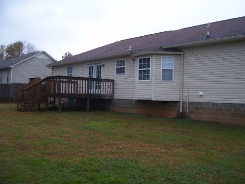 1988 Ford Bronco - Backyard scene shows a wooden deck attached to a house with beige siding. Another house is visible in the background.
