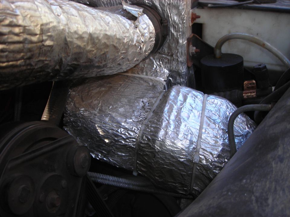 engine bay with insulated hoses and belts