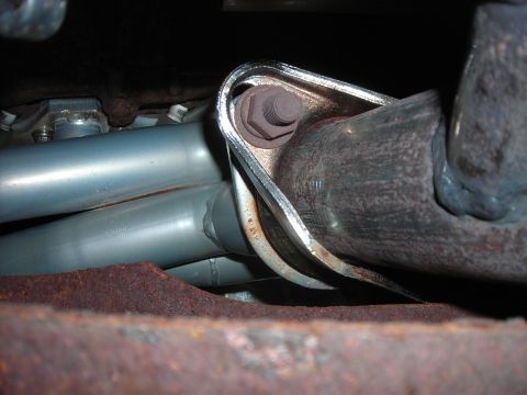1995 Ford Bronco - Close-up of an exhaust system component, showing a bolted bracket and pipe connection.