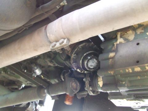 1990 Ford Bronco - Underside view of vehicle drivetrain components including driveshaft and transfer case.