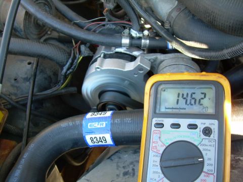 1988 Ford Bronco - A multimeter is used to check the voltage in the engine bay, showing 14.62V.