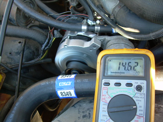 Close-up of engine bay with a multimeter reading 14.62 volts