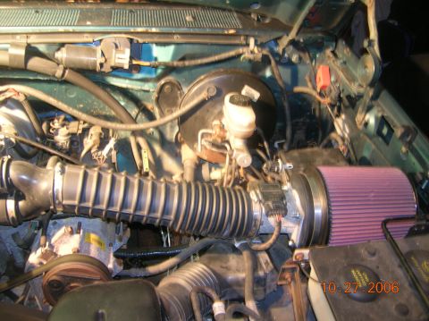 1996 Ford Bronco - Close-up of an engine bay showing an aftermarket air intake system.