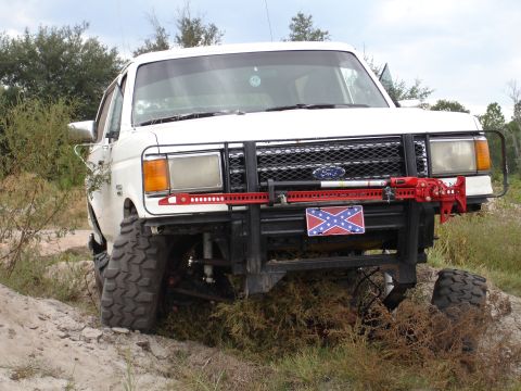 1989 Ford Bronco - This 1989 Ford Bronco features significant off-road modifications, including a lifted suspension and a heavy-duty front bumper.