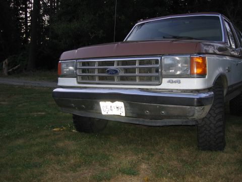 1987 Ford Bronco - Front view of a 1987 Ford Bronco, showing the grille, headlights, and "4x4" badging.