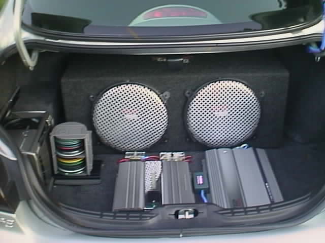 Trunk audio install with two subwoofers in a box, two amplifiers and a CD changer
