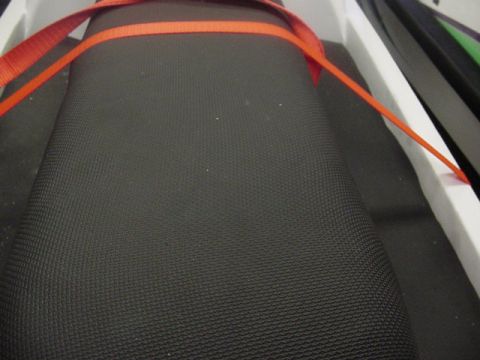 1995 Ford Mustang - Close-up of a car seat interior with orange straps, showing the textured fabric.