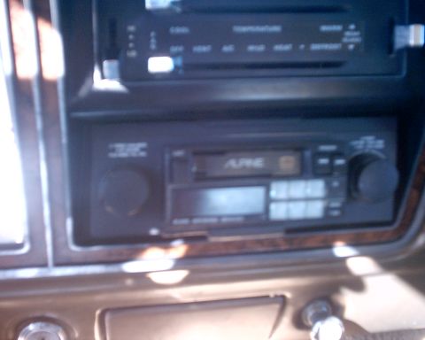 1979 Ford Bronco - Interior view of a car dashboard showing two car radios and wood trim details.