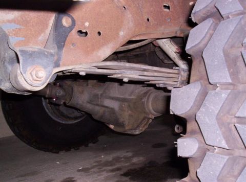 1995 Ford Bronco - Close-up view of the undercarriage, showing the rear axle and suspension system.