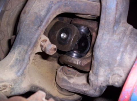 1995 Ford Bronco - Close-up view of a universal joint and suspension components on a vehicle.