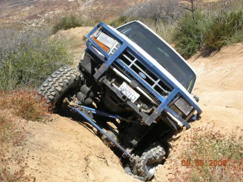 1995 Ford Bronco - This modified 1995 Ford Bronco navigates a steep, off-road incline, its extreme suspension and tire capabilities.