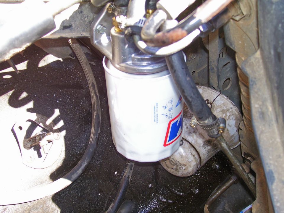 Close-up of an oil filter with hoses connected to it