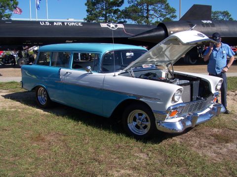 1973 Ford Ranchero - A classic two-tone station wagon is displayed with its hood open, parked in front of a U.S. Air Force jet.