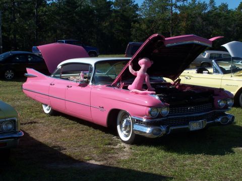 1973 Ford Ranchero - Pink 1959 Cadillac Coupe DeVille at a car show, a pink panther toy.