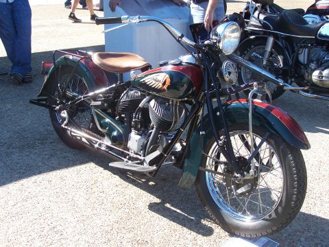 1973 Ford Ranchero - A vintage Indian motorcycle is parked next to another motorcycle at an outdoor event.