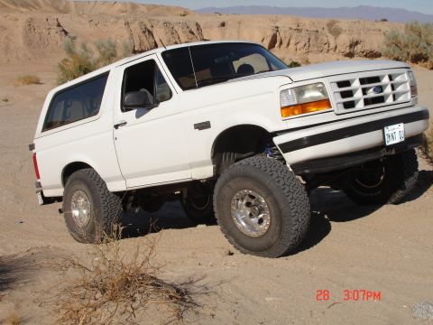 1996 Ford Bronco - This 1996 Ford Bronco is shown off-roading in a desert environment with its suspension lifted.