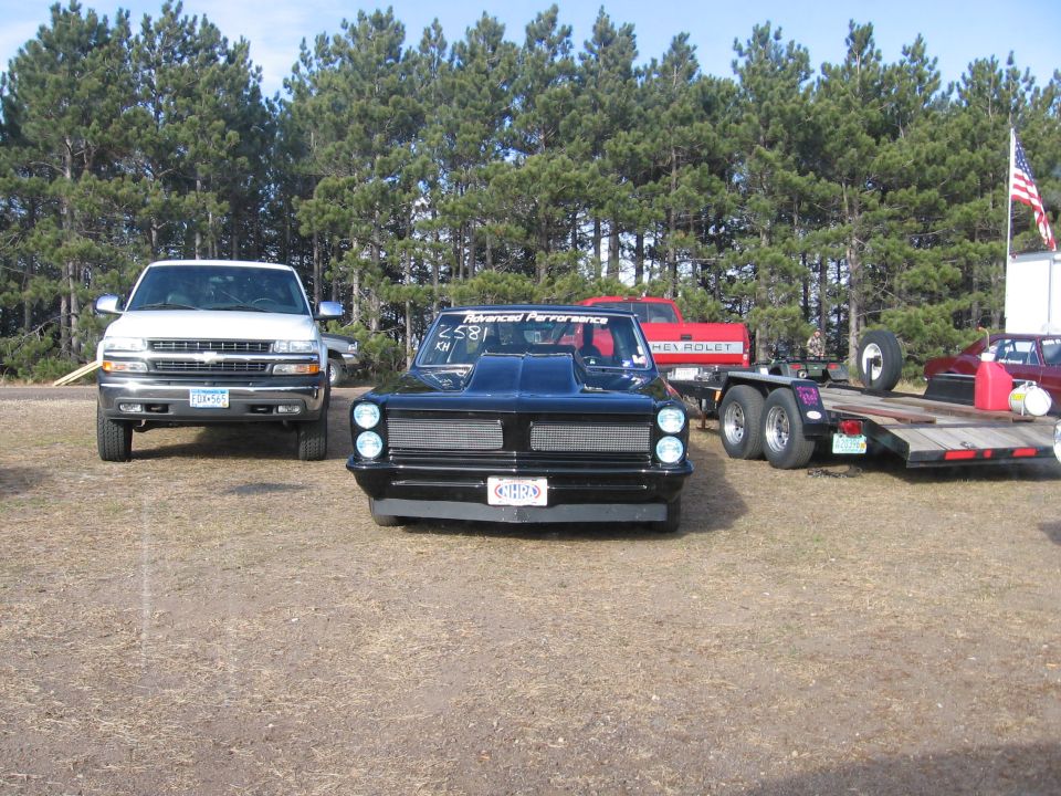 Black drag car with hood scoop and custom grille