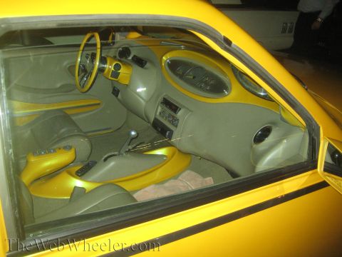 1968 Ford Mustang - Interior view of a heavily modified car with custom yellow accents and upholstery.
