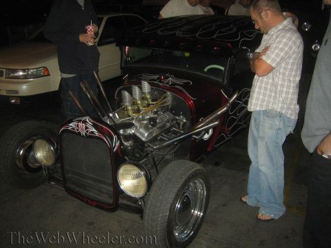 1968 Ford Mustang - A custom hot rod is displayed with its engine exposed, flame graphics and prominent exhaust pipes.
