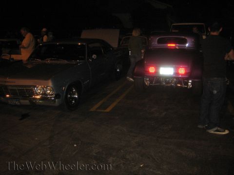 1968 Ford Mustang - Two classic cars, a 1965 Impala and a hot rod, are parked together at night.