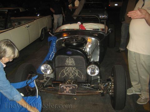 1968 Ford Mustang - A custom hot rod is displayed with a skull license plate and pinstripe artwork on its grille.