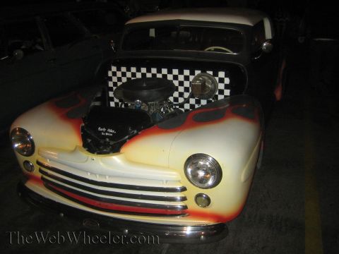 1968 Ford Mustang - Custom hot rod with flames and checkerboard pattern, engine exposed.
