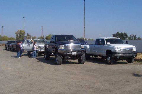 1994 Ford F-150 - Multiple pickup trucks are parked in an outdoor lot on a sunny day.