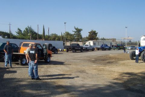 1994 Ford F-150 - Several trucks and vehicles are parked in an outdoor lot under a clear blue sky.