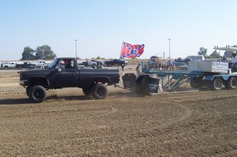 1994 Ford F-150 - Pickup truck competes in a sled pull event, with multiple vehicles visible in the background.
