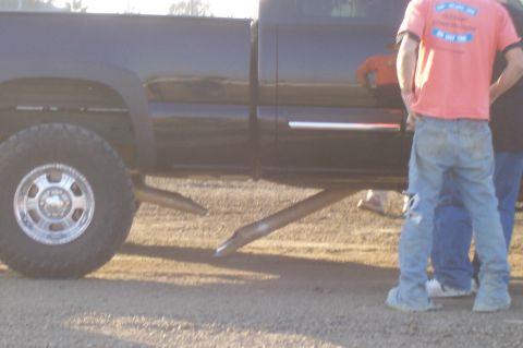 1994 Ford F-150 - Side view of a black pickup truck with chrome trim and large tires, parked outdoors.