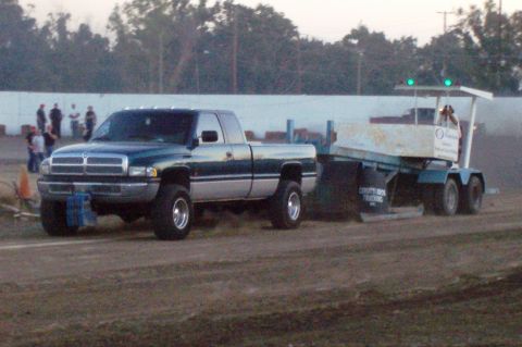 1994 Ford F-150 - A Dodge Ram pickup truck is seen towing a trailer during an event.