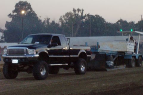 1994 Ford F-150 - A black 1994 Ford F-150 pickup truck is seen towing a trailer.